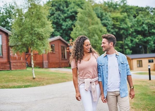 Couple walking outside Landal Sandybrook lodges