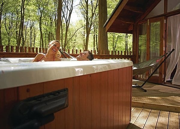 Couple enjoying outdoor hot tub at Golden Oak Hideaway